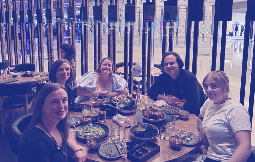 Guests at the Denada Agentic Supper Club around a dinner table